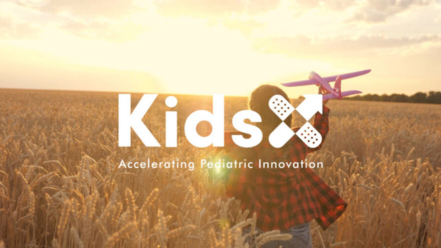 KidsX logo over cornfield background