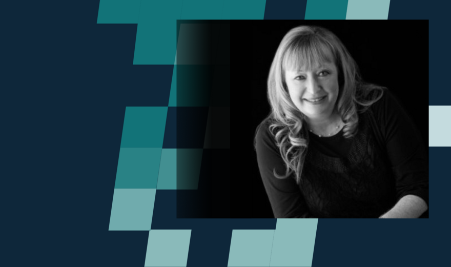A black and white headshot of Lesley Barton on a blue chequered background.