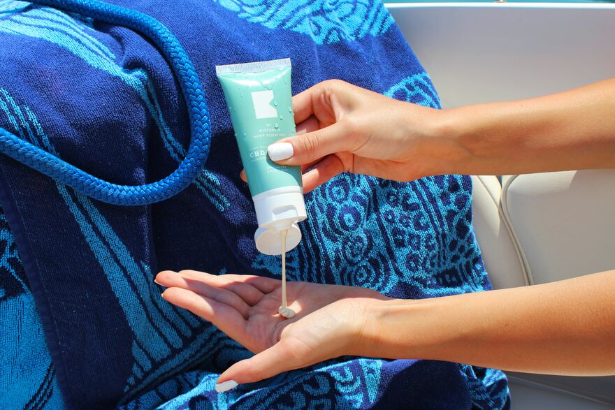Sunscreen being squeezed onto a hand