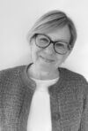A headshot of Janet WIld smiling
