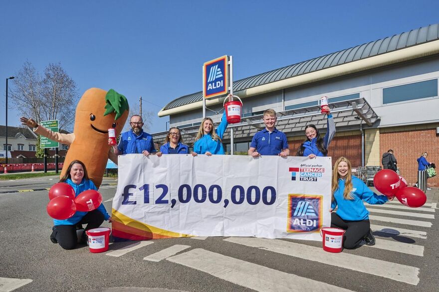 A picture of a group of people from Teenage Cancer Trust celebrating Aldi raising £12m to date